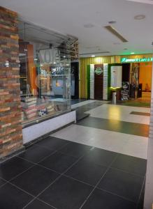 a lobby of a store with a tile floor at City Square Bay View in Alexandria
