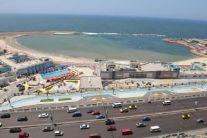 an aerial view of a beach and a road with cars at City Square Bay View in Alexandria