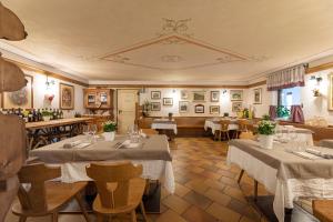 a restaurant with tables and chairs in a room at Rifugio Cereda in Fiera di Primiero