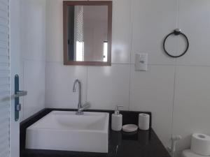 a white bathroom with a sink and a mirror at Cantinho da Gê-"Sinta-se a vontade!"-Maragogi in Maragogi +19 photos