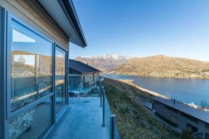 a house with a view of a body of water at Executive Living in Bluewater - 3 Bedroom Apartment in Queenstown