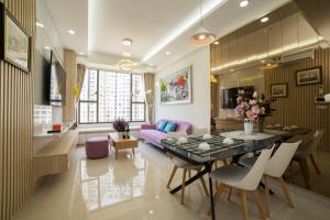 a dining room and living room with a table and chairs at RiverGate Residence in Ho Chi Minh City
