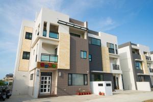 a tall white and brown building at Sunny Breeze Penghu in Magong