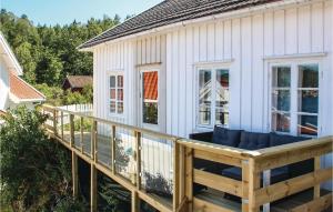 a porch of a white house with a deck at Amazing Home In Staubø With Wifi in Staubø