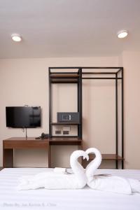 two white swans making a heart on a bed at Griffin Hotel and Suites in Cebu City