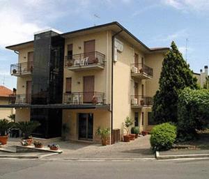 a large building with balconies on the side of a street at Hotel I Due Cigni in Montepulciano