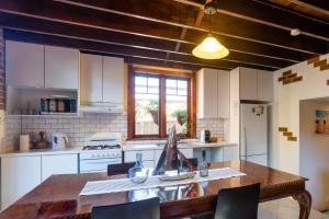 a kitchen with a wooden table with chairs in it at 5 Stars Sydney City & Airport Retreat in Sydney