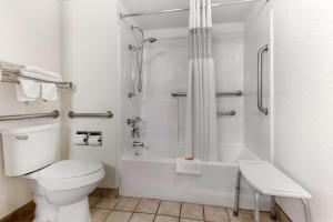 a bathroom with a toilet and a shower and a sink at SureStay Hotel by Best Western Phoenix Airport in Phoenix