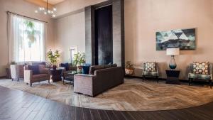 a lobby with couches and chairs on a wooden floor at Best Western Plus North Las Vegas Inn & Suites in Las Vegas