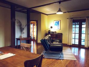 a living room with a leather chair and a table at Pieter van Gent Winery & Vineyard in Eurunderee
