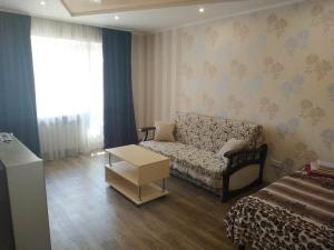 a living room with a couch and a table at Apartment at Kirova (A.Polia) in Dnipro