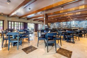 Quality Inn Mazatlan في مازاتلان: غرفة طعام مع طاولات وكراسي في مطعم