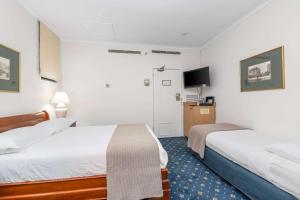 Säng eller sängar i ett rum på Castlereagh Boutique Hotel, Ascend Hotel Collection