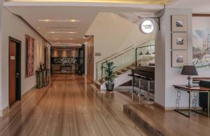 a hallway with wooden floors and stairs in a building at PrimeBiz Hotel Surabaya in Surabaya