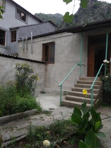 a house with a staircase leading to a door at Family Guest House in Alaverdi