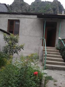 a house with stairs leading to a door at Family Guest House in Alaverdi