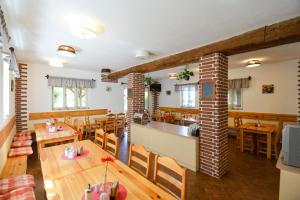 a restaurant with wooden tables and chairs and a bar at Horská Chata na Špici in Benecko