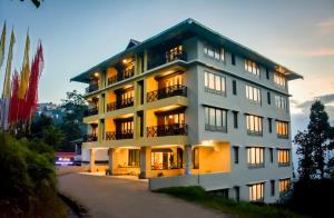a hotel with a building in the foreground at Udaan Olive Hotel & Spa, Pelling in Pelling