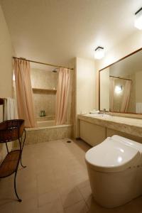 a bathroom with a toilet and a sink and a tub at Hotel Concorde Hamamatsu in Hamamatsu