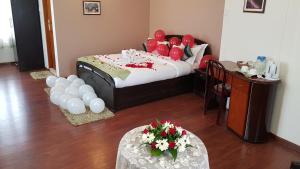 a bed and a table in a room at Hotel Woodland Hill Stay in Shillong