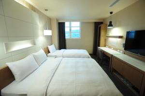 Postel nebo postele na pokoji v ubytování Kindness Hotel Hualien