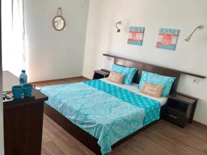 a bedroom with a bed with a blue comforter at Casa Lotca in Costinesti +33 photos