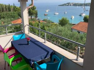 a balcony with a table and chairs and a view of the water at Apartment Excellent in Nečujam