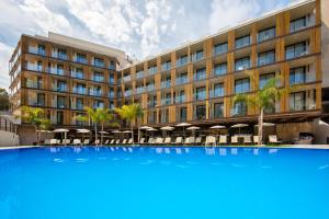 a large building with a large blue pool in front of it at Golden Costa Salou - Adults Only 4* Sup in Salou