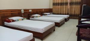 a group of four beds in a room at Hue Railway Hotel in Hue