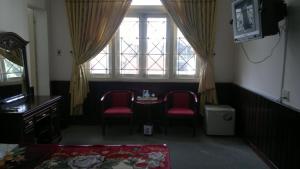 a room with a table and two chairs and a window at Hue Railway Hotel in Hue