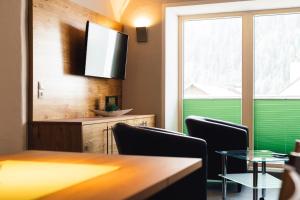 Telewizja i/lub zestaw kina domowego w obiekcie Nowders Apartments