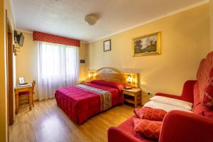 Postel nebo postele na pokoji v ubytování Hotel Club Funivia