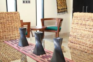 
a table with two chairs and two vases on it at Nike Villas in Sanur
