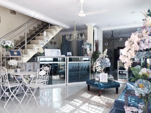 a room with a staircase and a table and chairs at AAM Hotel in Kota Bharu