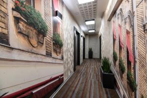 an empty hallway of a building with plants on the walls at Hotel Perfect in Krakow
