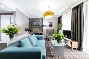 a living room filled with furniture and a couch at Hotel Perfect in Kraków