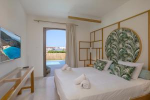 a bedroom with a bed with a large headboard at Agave Boutique Hotel in Laganas