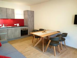 a kitchen with a wooden table and chairs at Versigglhof in Appiano sulla Strada del Vino