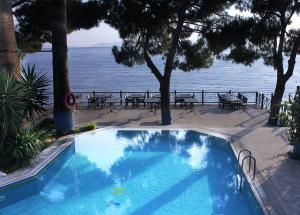 a swimming pool with a view of the water at Arora Hotel in Kusadası