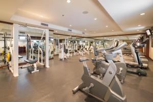 a gym with treadmills and elliptical machines at Zenith Sukhumvit Hotel - SHA Extra Plus in Bangkok