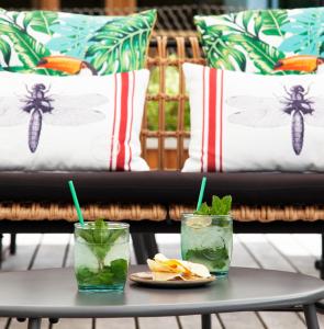 two drinks on a table with a couch in the background at Hotel Arima & Spa - Small Luxury Hotels in Donostia-San Sebastián