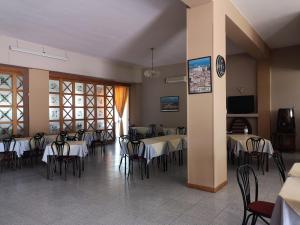 a dining room with tables and chairs in a building at Hotel ausonia in Corigliano Calabro