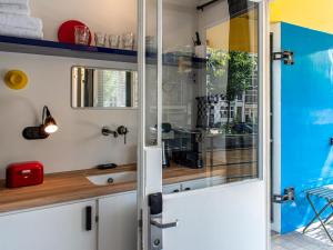 a small kitchen with a sliding glass door at SWEETS - Hortusbrug in Amsterdam