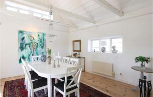 - une salle à manger blanche avec une table et des chaises blanches dans l'établissement Amazing Home In Lderup With House A Panoramic View, à Löderup