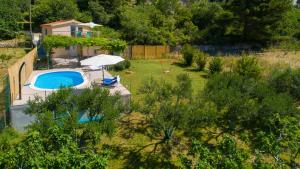 a backyard with a swimming pool and a house at Holiday Home Rupotina with a large yard, pool and a beautiful view in Solin