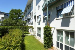 a side view of an apartment building with a yard at FANA Pension in Haar