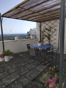 a blue table and chairs on a patio with a view at IL PRINCIPE VIENDALMARE in Ostuni