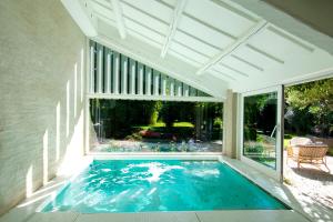 a swimming pool in the middle of a house at DelleFarfalle Boutique B&B in Santarcangelo di Romagna