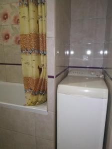 a shower curtain next to a toilet in a bathroom at Apartment at Kirova (A.Polia) in Dnipro +11 photos