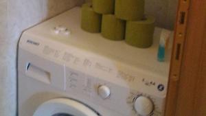 a washing machine with green towels on top of it at Residence degli Artisti in Desenzano del Garda